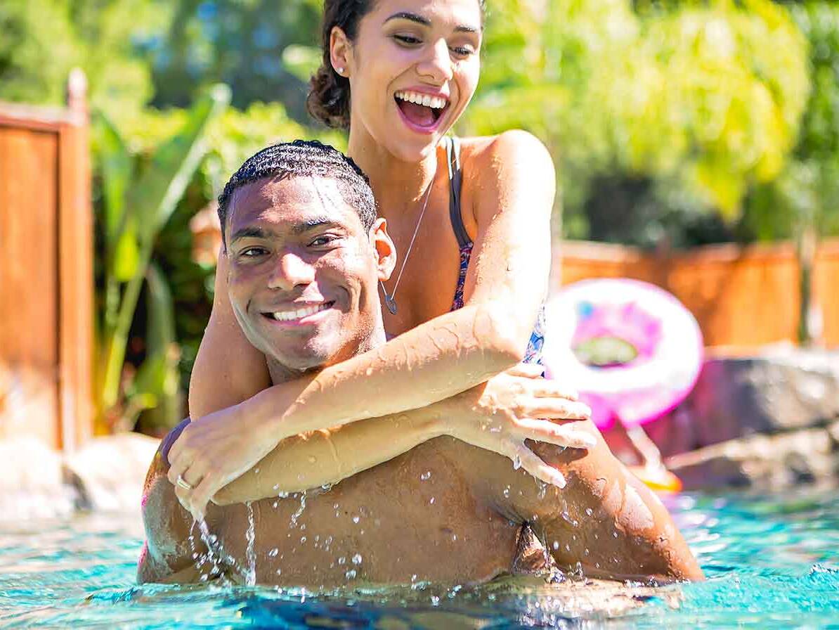 Happy couple in their swimming pool